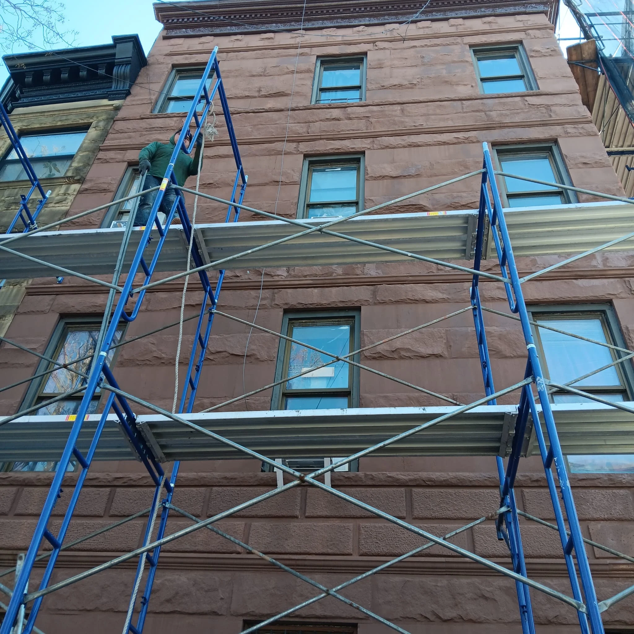 Metal scaffolding system installed on residential building in Queens NY for exterior work