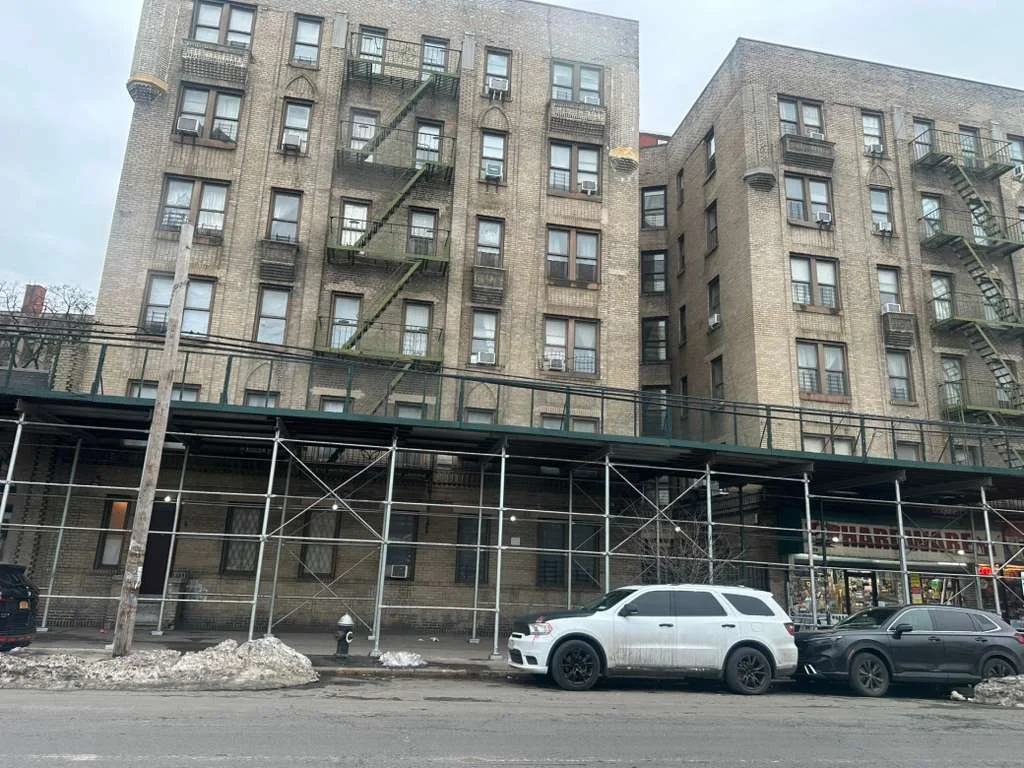 Sidewalk shed scaffolding installed along residential building in Queens NY for pedestrian protection