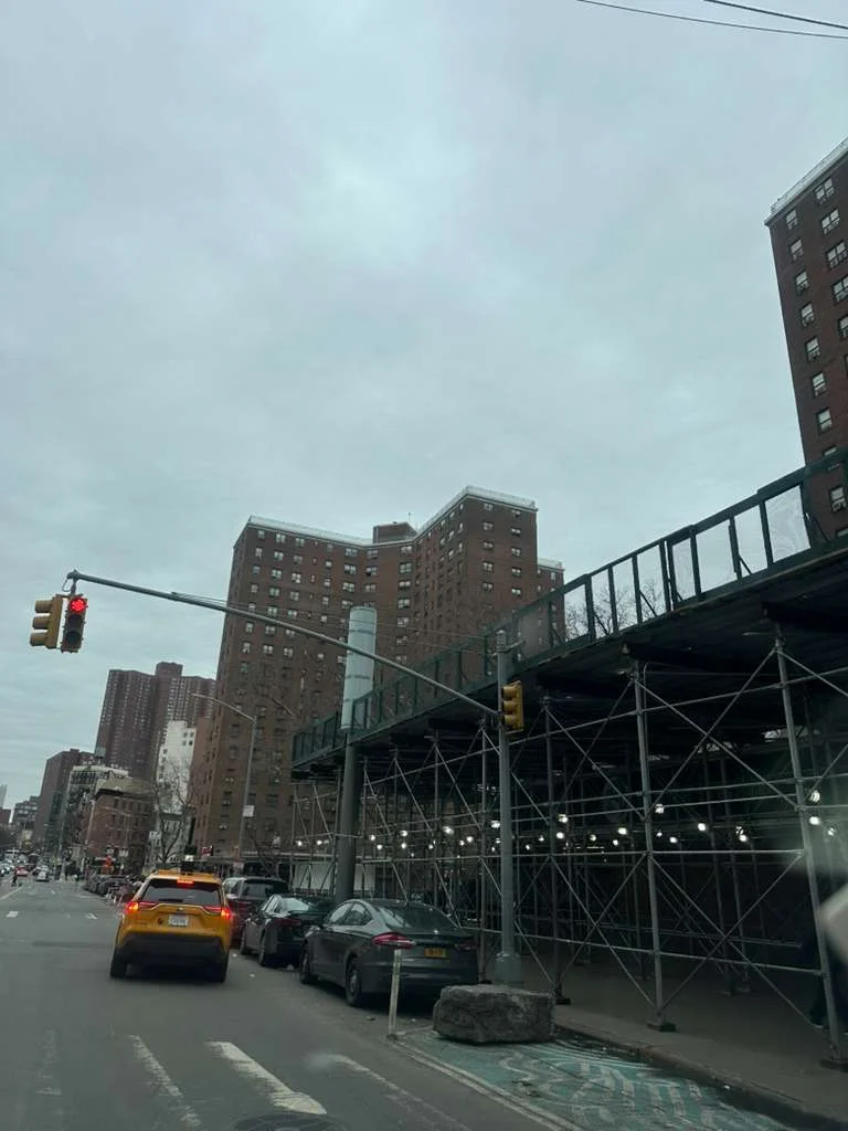 Sidewalk shed and scaffolding covering street in Queens New York for pedestrian safety