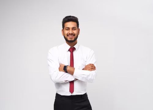 portrait-young-indian-top-manager-t-shirt-tie-crossed-arms-smiling-white-isolated-wall_496169-1513